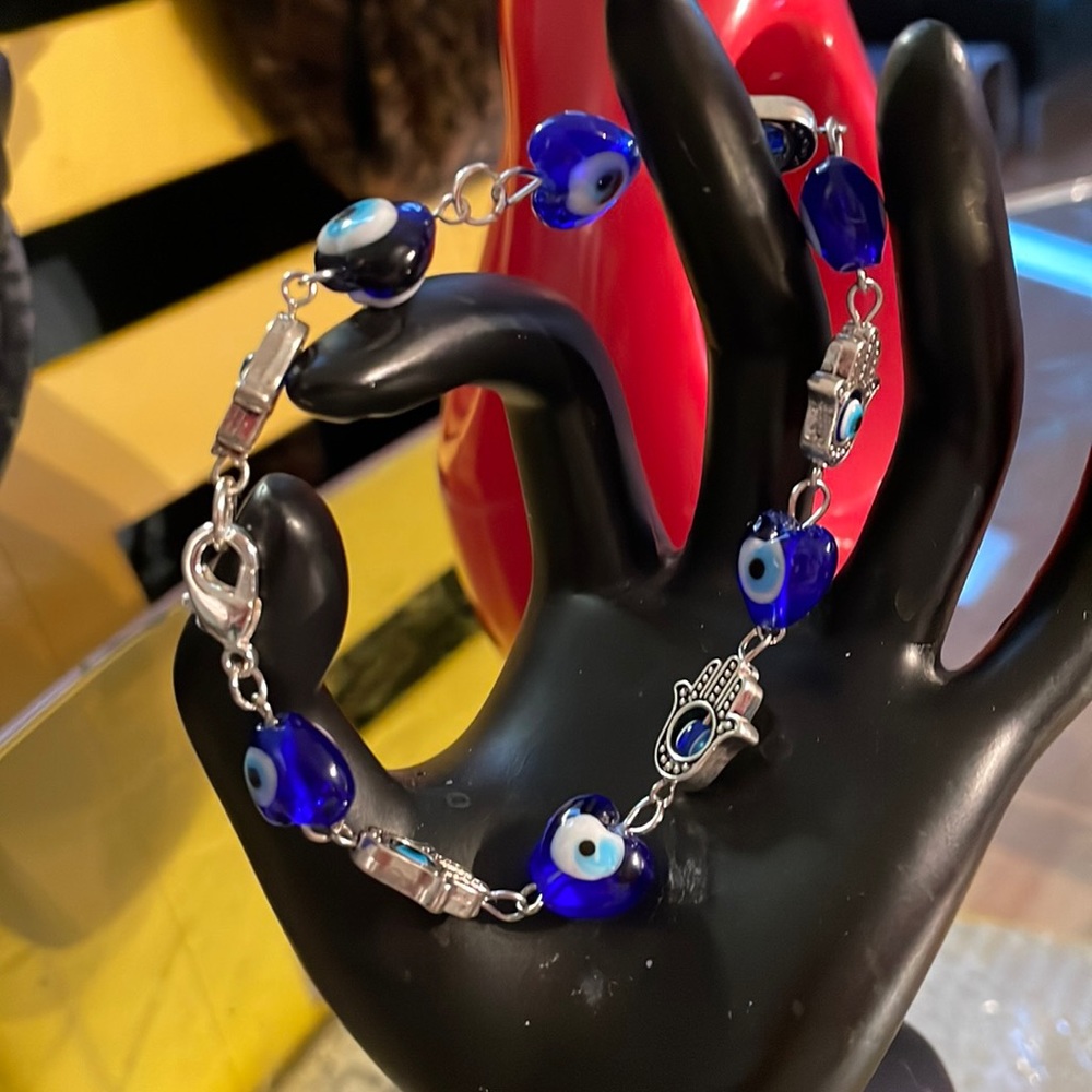 Outstanding hamsa and evil eye in silver and sapphire blue. Sapphire are glass